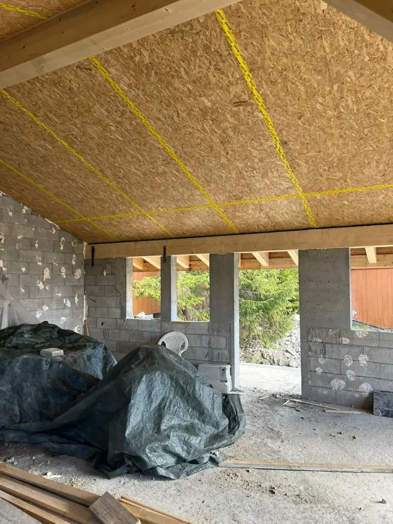 Interior renovation view showing insulation installed beneath the ceiling