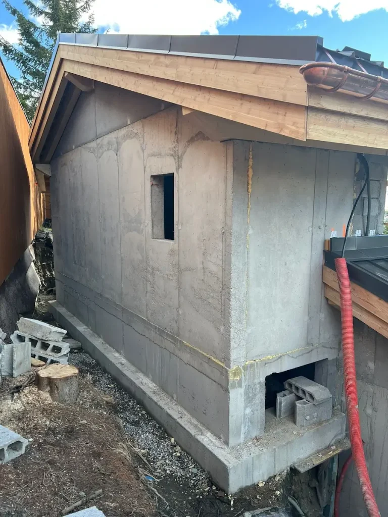 Chalet roof and stone chimney during exterior renovation work