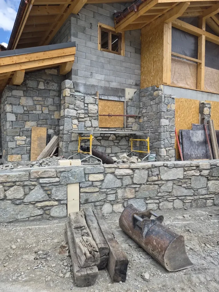 Stone exterior wall and construction materials during chalet renovation