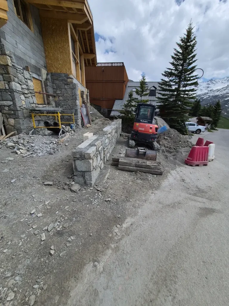 Chalet construction area with materials and tools on site