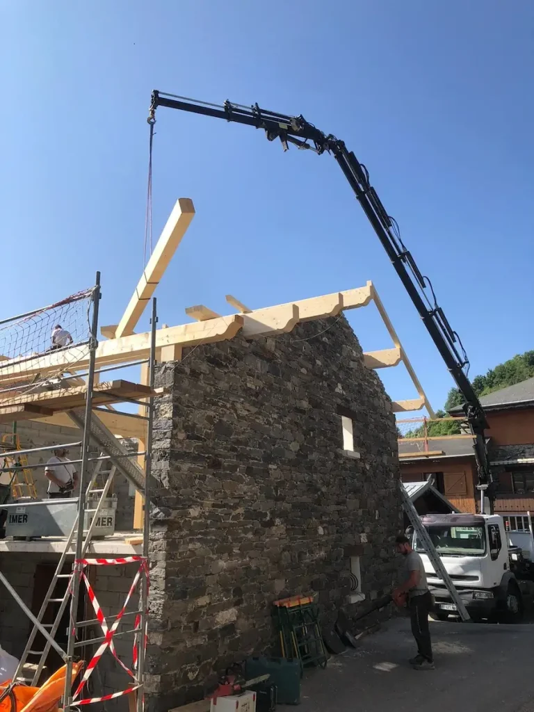 Timber roof beam being lifted by crane at Chalet La Grange