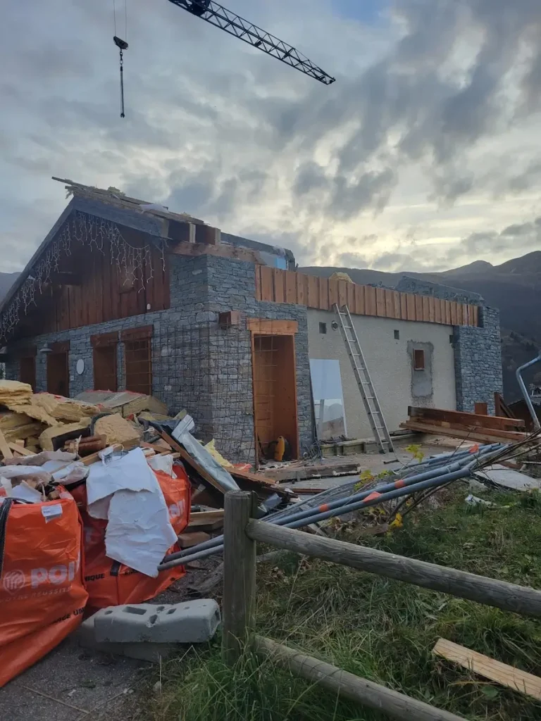 Chalet exterior during renovation with building materials outside