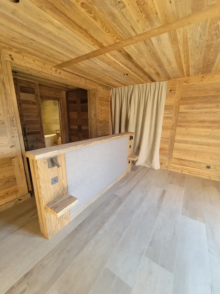 Timber bedroom interior at Chalet La Rochette with bespoke joinery headboard and other bedroom features