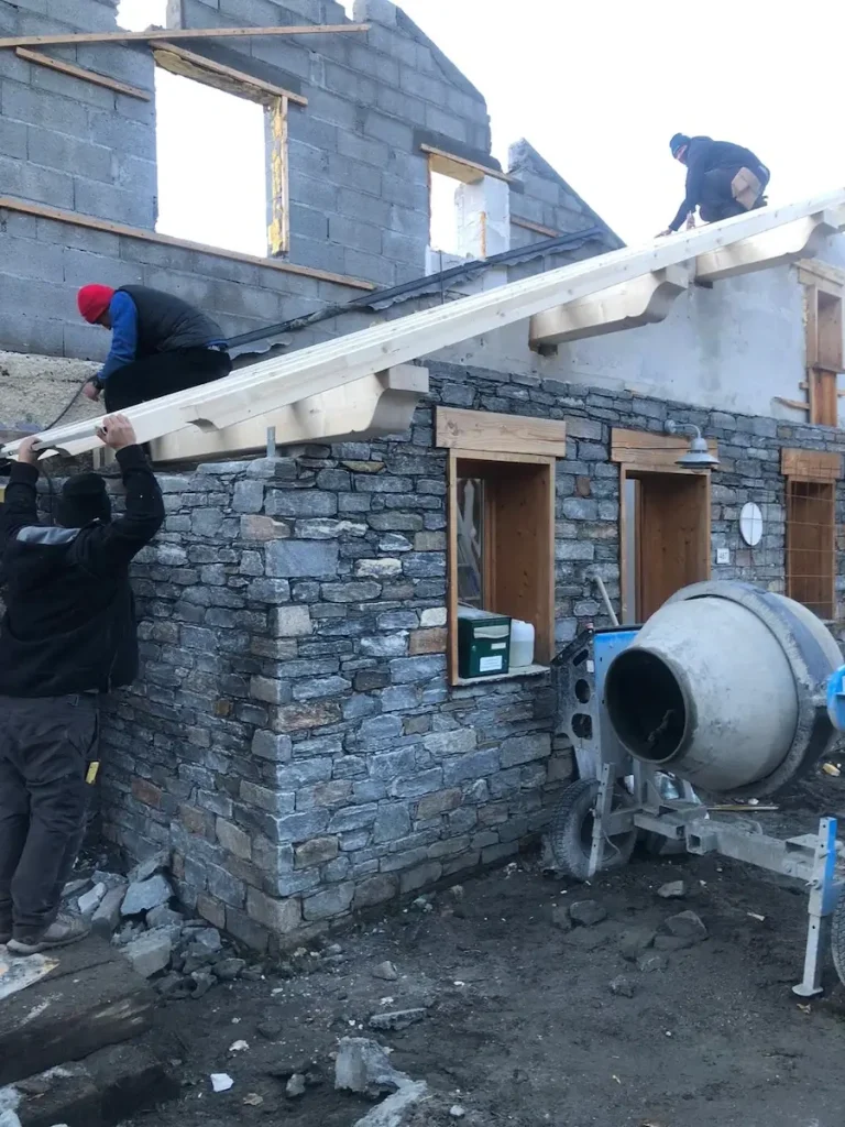 Crane lifting materials during chalet roof renovation