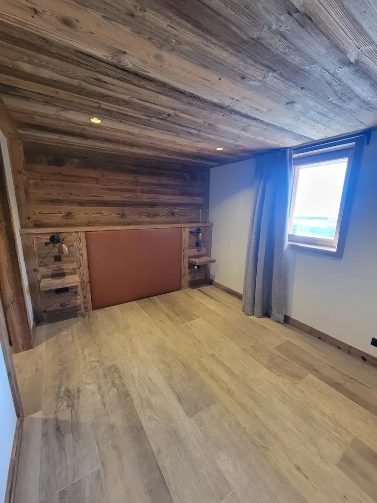 Wooden bedroom with mountain view at Chalet La Rochette featuring bespoke joinery