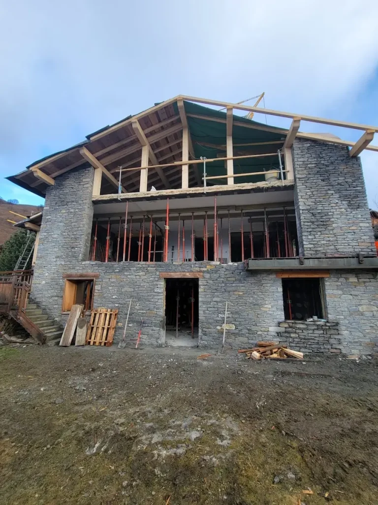 Chalet extension under construction with timber roof frame 09-chalet-pelozet.webp: Chalet roof framing during renovation