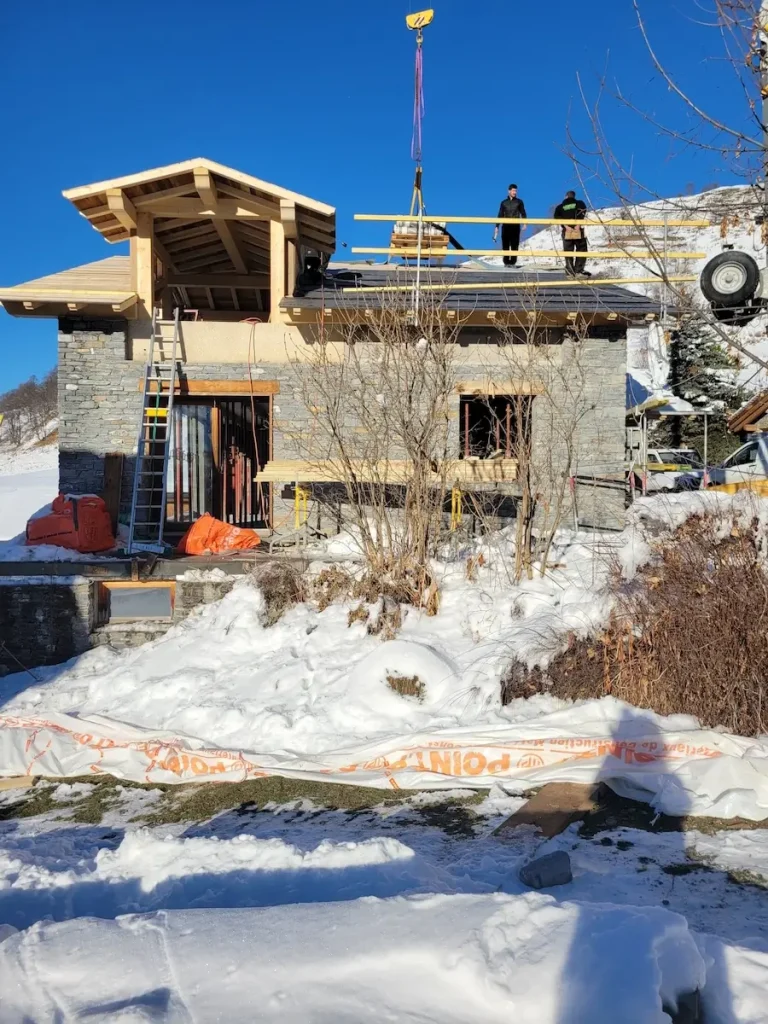 Chalet renovation with exposed roof structure in snow