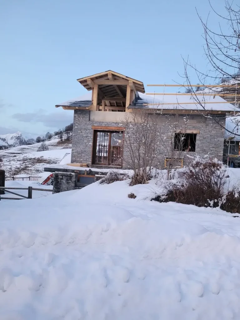 Chalet exterior before renovation in snowy setting