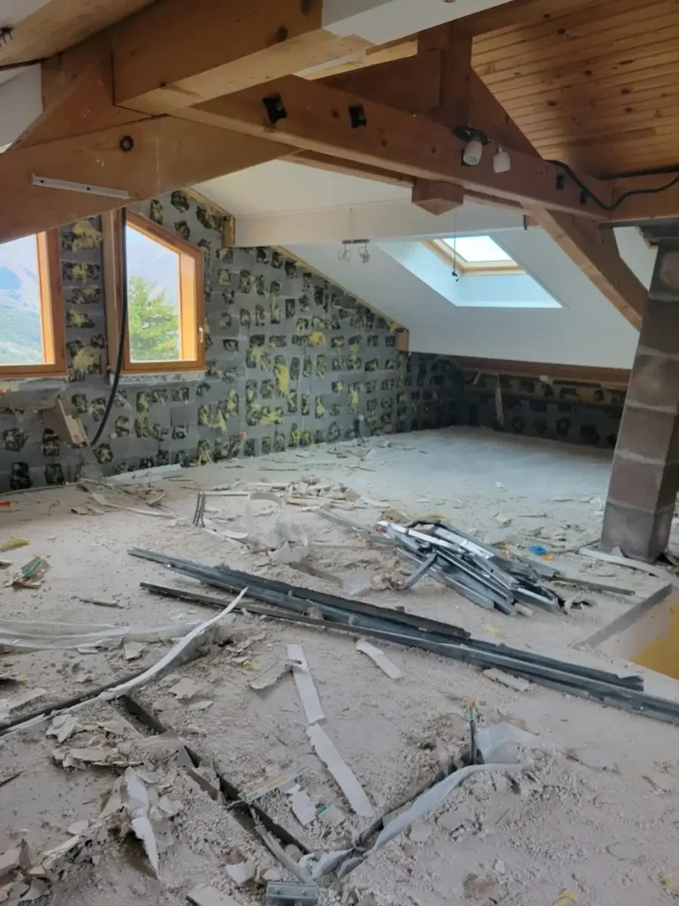 Finished attic room with exposed beams and skylight