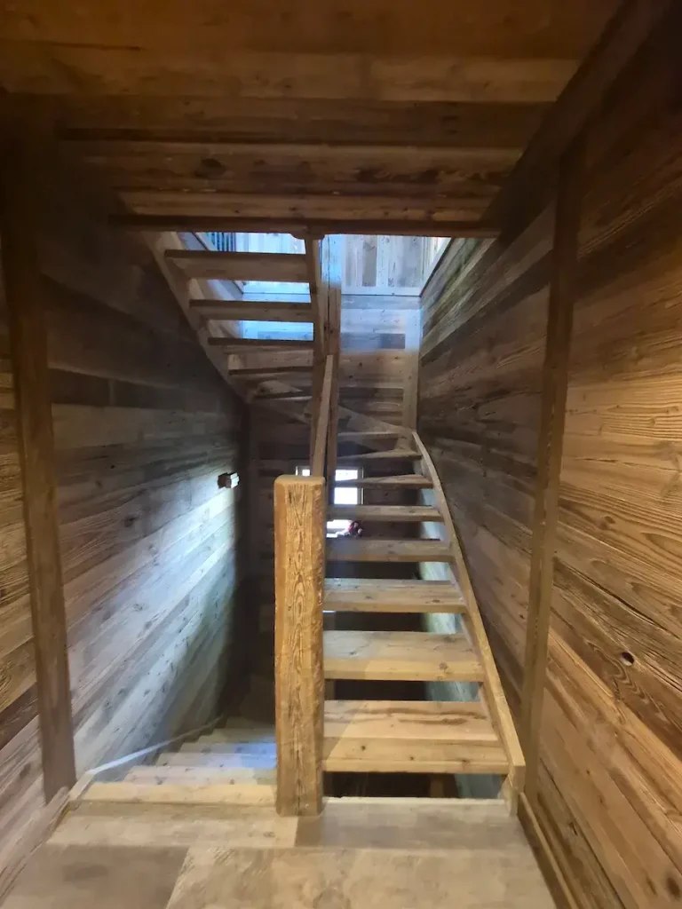 Timber staircase leading between floors inside a renovated chalet